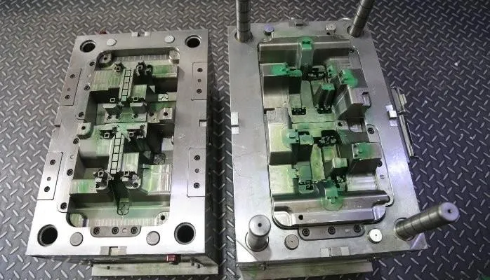 Precision injection molding tools on a workbench